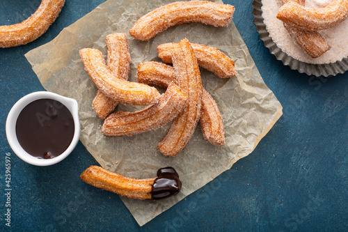 Homemade churros with cinnamon sugar on parchment