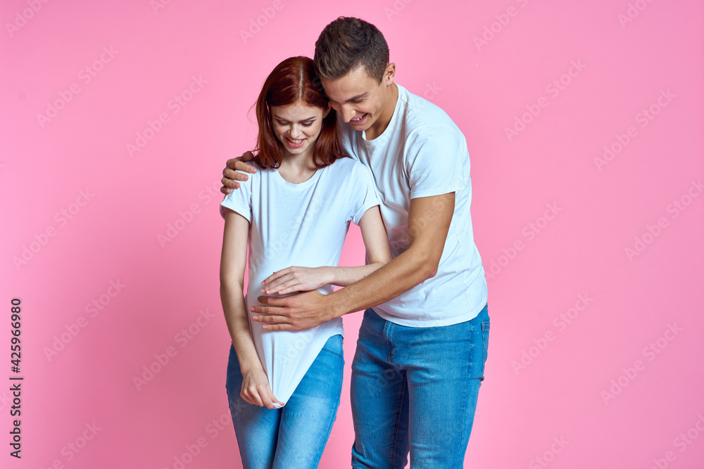 young couple family parents pink background hug young couple family parents pink background hug