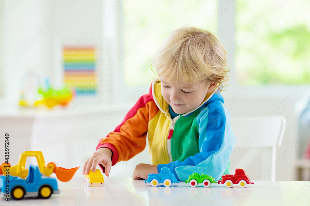 Boy playing toy cars. Kid with toys. Child and car - obrazy, fototapety, plakaty 
