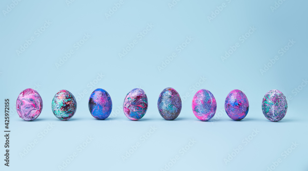 Colorful painted shiny eggs on blue background. Colorful painted shiny eggs on blue background.