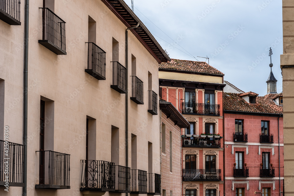 Old Traditional Residential Buildings in Central Madrid. Colorful Facades Against Cloudy Sky
