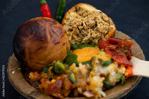 Litti Chokha Or Liti Choka From Bihar Jharkhand And Uttar Pradesh UP Is Stuffed With Chana Sattu. Served With Alu Or Aloo Baingan Bharta Desi Ghee Lehsun Adrakh Lehsoon Chutney Achar Mirchi And Pyaj photo