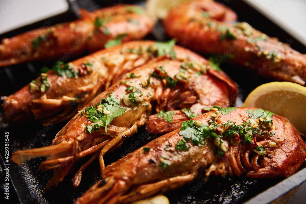 Grilled large shrimps with lemon and spices on the grill pan