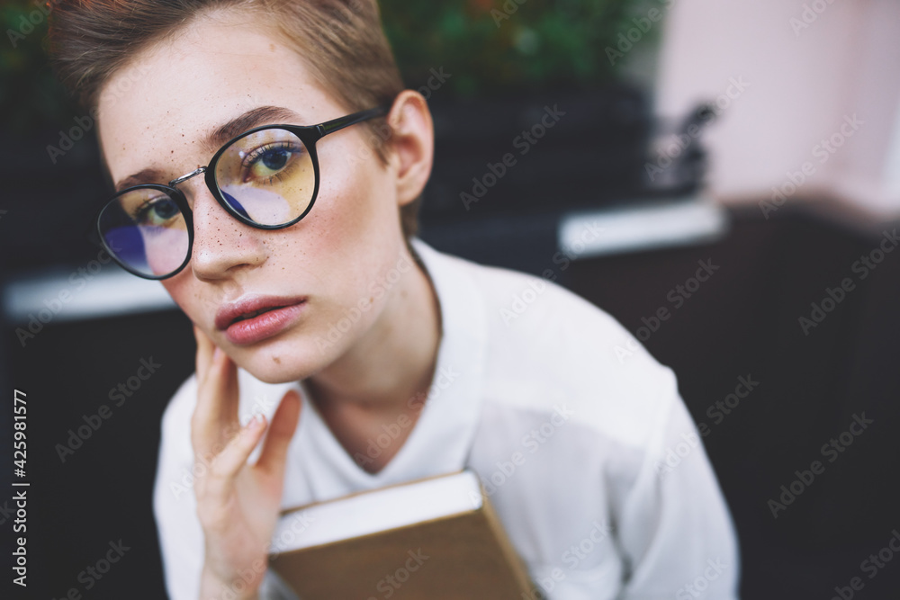 education woman in glasses with book at table education woman in glasses with book at table