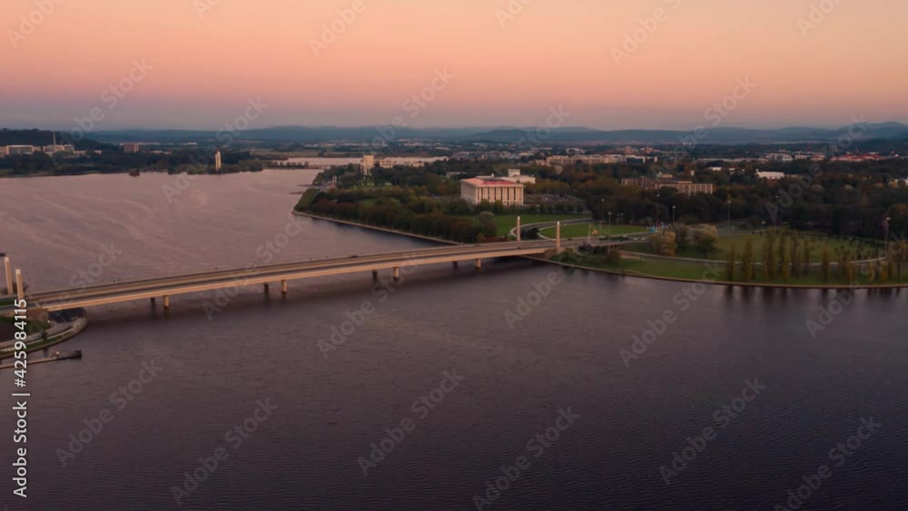 Aerial hyperlapse of Commonwealth Bridge on Lake Burley Griffin during a beautiful sunset in Canberra, the capital of Australia Aerial hyperlapse of Commonwealth Bridge on Lake Burley Griffin during a beautiful sunset in Canberra, the capital of Australia