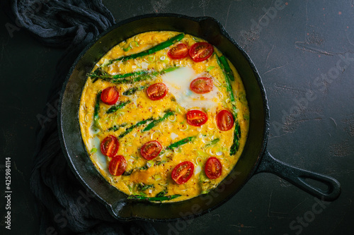 Delicious fritatta with green asparagus and cherry tomatoes