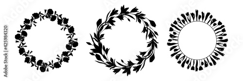 Set of vector wreaths in black ink on a white background. Flowers and herbs are hand-drawn. Natural plants from leaves, roses, lilies. Botany and flora. Round design for medicine, postcards, cosmetics