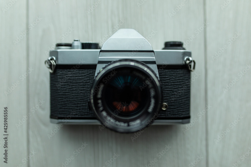 Old camera with photographs on a gray concrete background