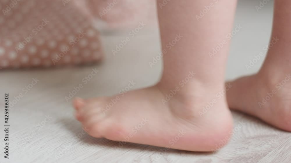 child small heels walk on the white parquet floor of the house child small heels walk on the white parquet floor of the house