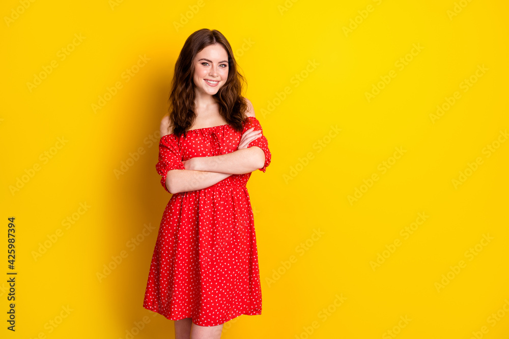 Photo portrait of pretty woman with folded hands smiling in red dress isolated bright yellow color background copyspace Photo portrait of pretty woman with folded hands smiling in red dress isolated bright yellow color background copyspace