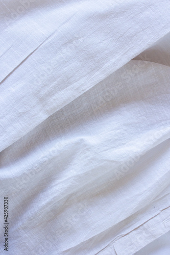 Folds of beige fabric, linen cotton texture close up, light material macro