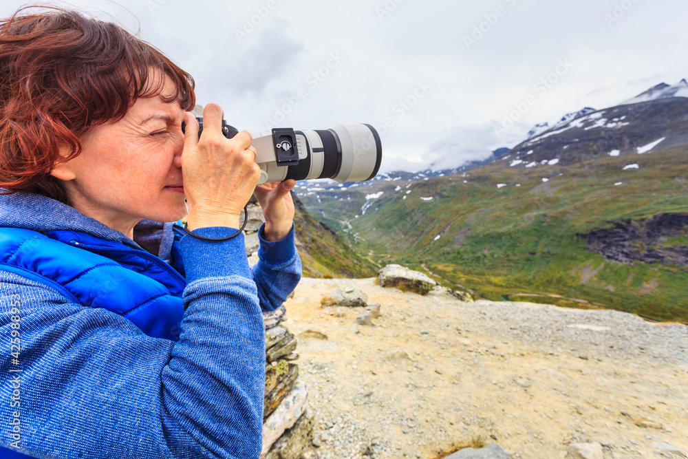 Tourist with camera in Norway mountains