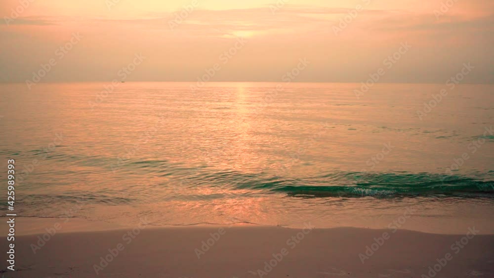 The view of the beach in the morning. The sea waves hit the shore in the summer of Thailand. The view of the beach in the morning. The sea waves hit the shore in the summer of Thailand.