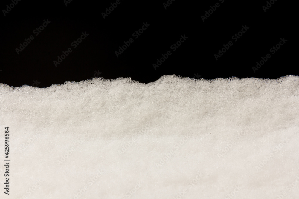 Fototapeta Heap of white snow on black background.The structure of snow and ice. Close-up.