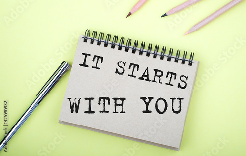 Wallpaper Mural It Starts With You text on the notebook with pen on yellow background Torontodigital.ca