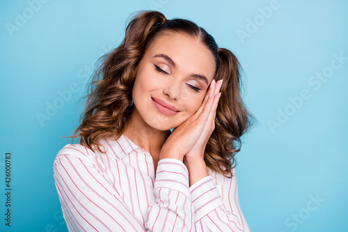 Portrait of lovely dreamy cheerful brown-haired girl sleeping resting isolated over vivid blue color background