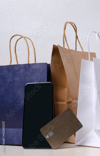 Vertical image of shopping bags, smartphone and credit card.Concept of online shopping and delivery