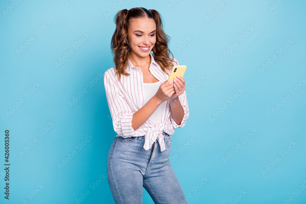 Photo portrait smiling texting reading news subscribing on cellphone isolated vivid blue color background Photo portrait smiling texting reading news subscribing on cellphone isolated vivid blue color background