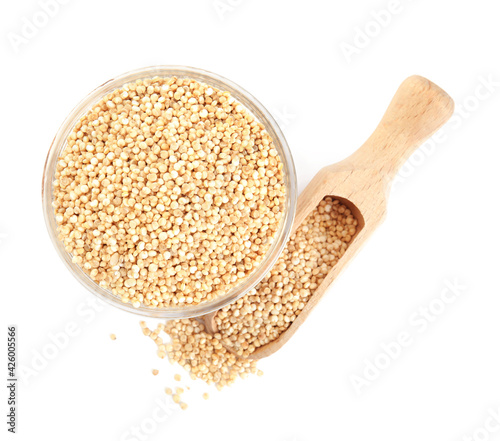 Bowl and wooden scoop with quinoa on white background, top view