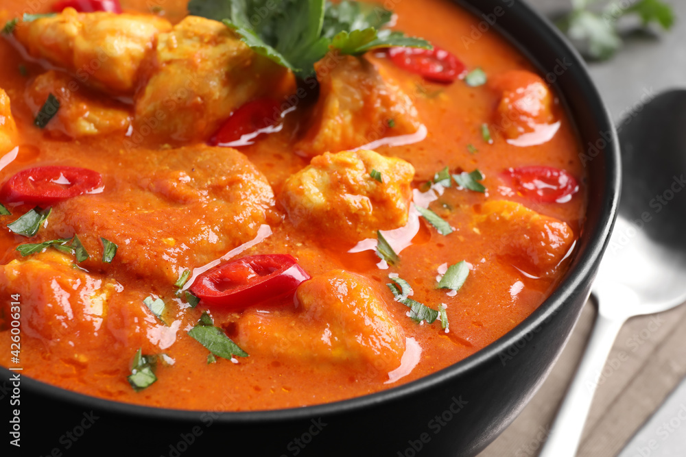 Bowl of delicious chicken curry on table, closeup Bowl of delicious chicken curry on table, closeup