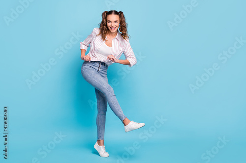 Full length body size photo of girl with tails dancing kicking at party isolated vivid blue color background