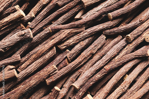 Dried sticks of liquorice root as background, top view photo