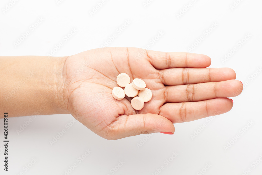 Macro Close up of medicinal or herbal multi-color tablet, capsule, and pill on a female hand palm. Top view, Macro Close up of medicinal or herbal multi-color tablet, capsule, and pill on a female hand palm. Top view,