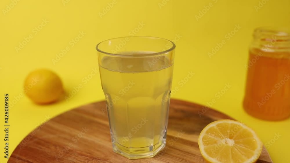 Lemonade on yellow backgrounnd with honey and lemon