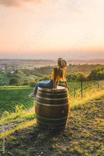 Happy girl on top of vineyard hill at sunset in Friuli Venezia Giulia region, Italy photo