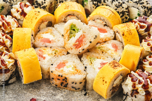 Japanese traditional cuisine: sushi. Assortment of sushi rolls on a gray background