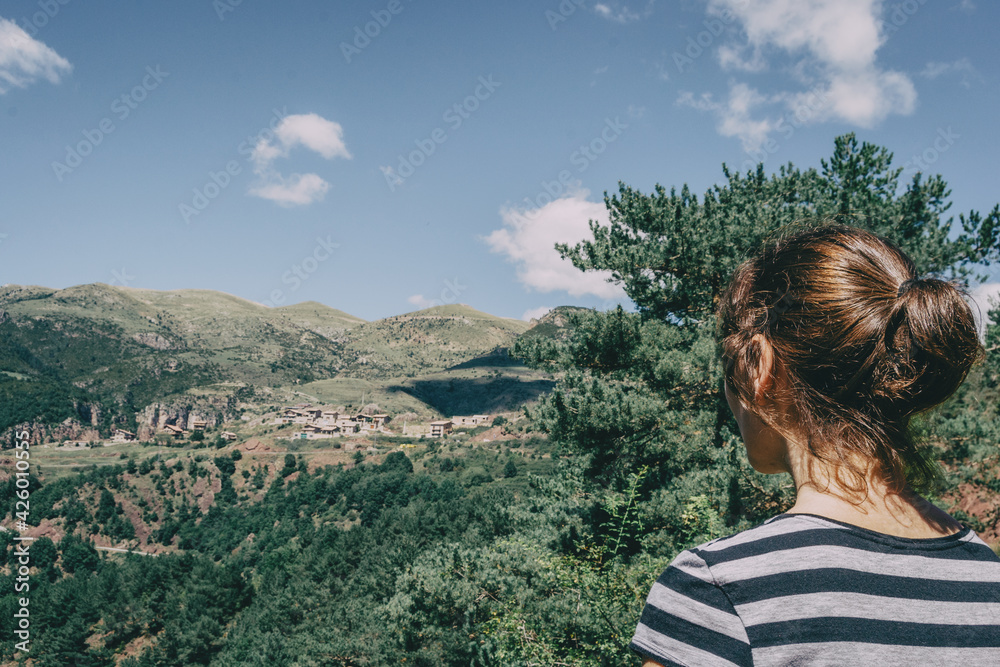 Girl walking along a small path in the mountain of Spain.