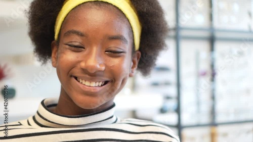 Pretty african american teen school girl looking at camera, happy black teenager, portrait