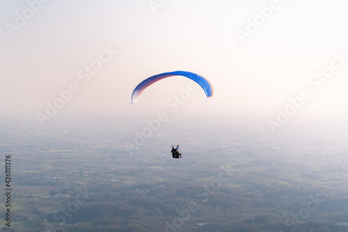 Paraglider isolated in the blue sky