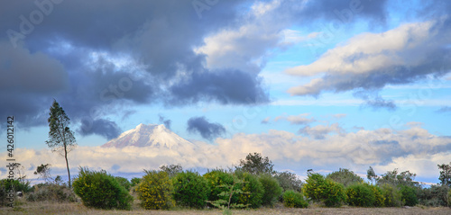 View of Cotopaxi volcano in Ecuador, with a dramatic stormy sky