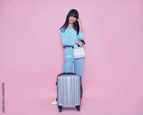 Woman with suitcase and smartphone