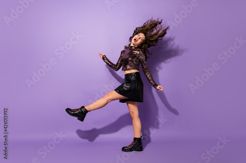 Full length body size view of carefree lovely cheerful dreamy girl dancing having fun rest isolated over bright violet color background