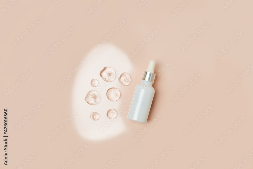 Pipette serum bottle dose of fluid hyaluronic acid with gel drops on neutral beige background. Cosmetics concept. Flat lay, copy space, dermatology beauty concept Pipette serum bottle dose of fluid hyaluronic acid with gel drops on neutral beige background. Cosmetics concept. Flat lay, copy space, dermatology beauty concept