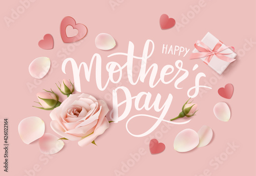 Happy Mothers day. Calligraphic greeting text. Holiday design template with realistic rose flower, bud,petal and gift box on pink background. Vector stock illustration.