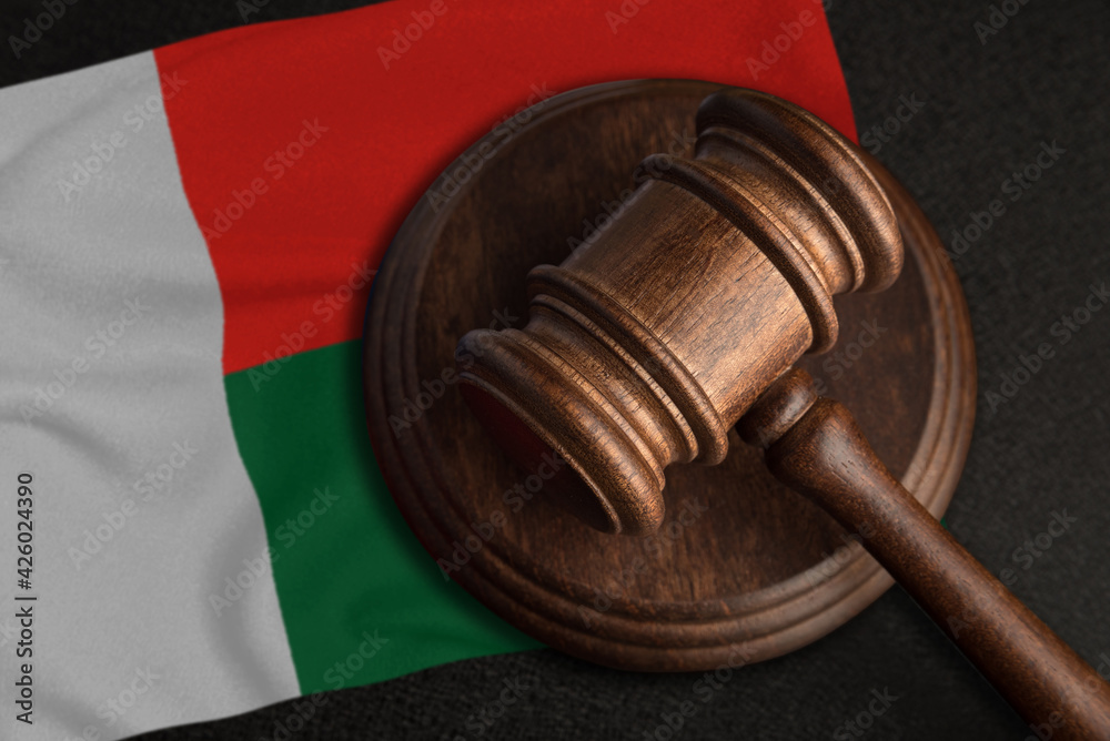 Judge gavel and flag of Madagascar. Law and justice in Madagascar. Violation of rights and freedoms