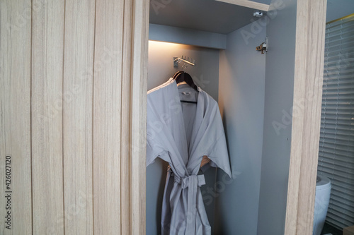 Selective focus close up wooden wardrobe with bathrobe for shower