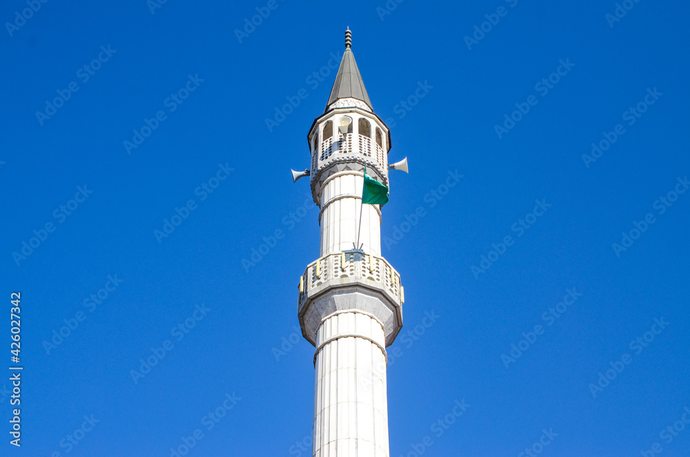 Mosque minaret against blue sky.  