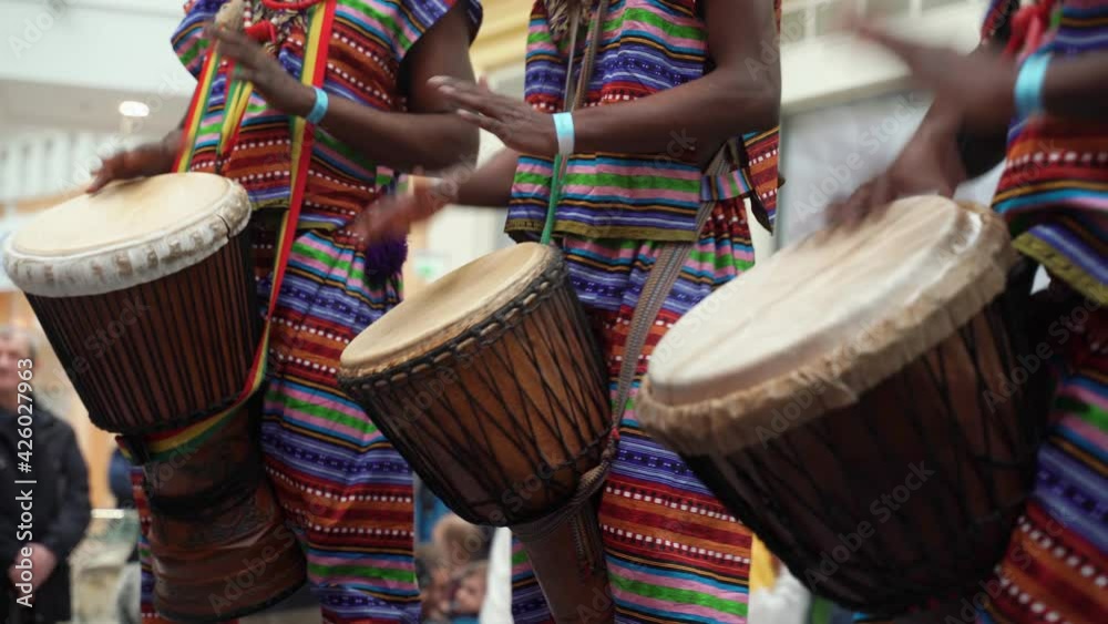 Man playing drum by his hands. Street performance using percussion instruments in slow motion