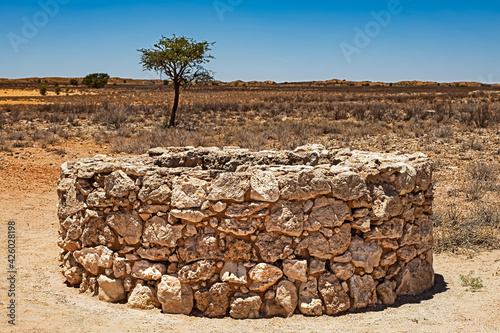 Old stone well in dry Kalahari photo