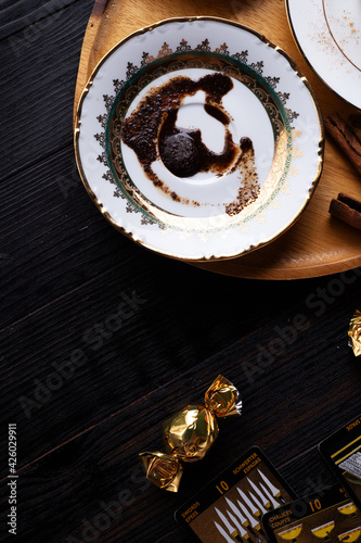 spelling coffee plate  with  coffee grounds and Tarot cards served at dark wooden table. devination concept photo