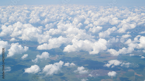 Lot of small sky from the plane. Small cute a lot of clouds in the sky, view from plane, bird eye view. Aerial view © Nataliia Karabin