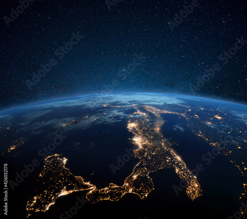 Fototapeta Naklejka Na Ścianę i Meble -  Beautiful blue planet earth with night city lights. Central Europe and Italy at night view from space. Modern cities and electricity
