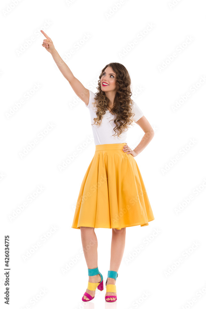 Beautiful Young Woman Is Looking Up And Pointing Beautiful Young Woman Is Looking Up And Pointing