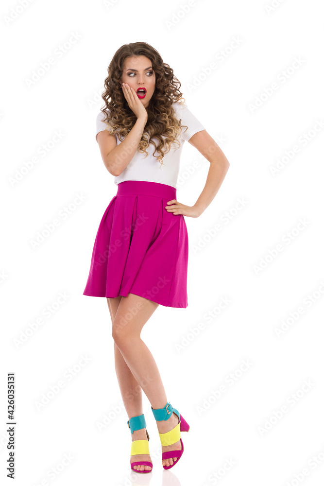 Surprised Young Woman Is Holding Hand On Chin And Looking Away Surprised Young Woman Is Holding Hand On Chin And Looking Away
