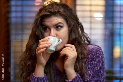 Young woman having cofee in a restaurant photo