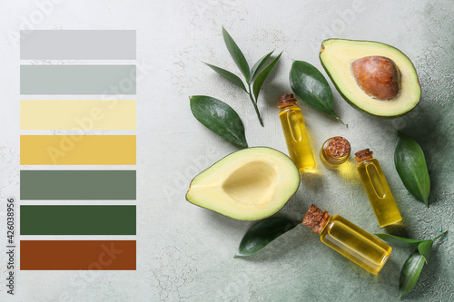 Composition with bottles of essential oil and avocado on color background. Different color patterns